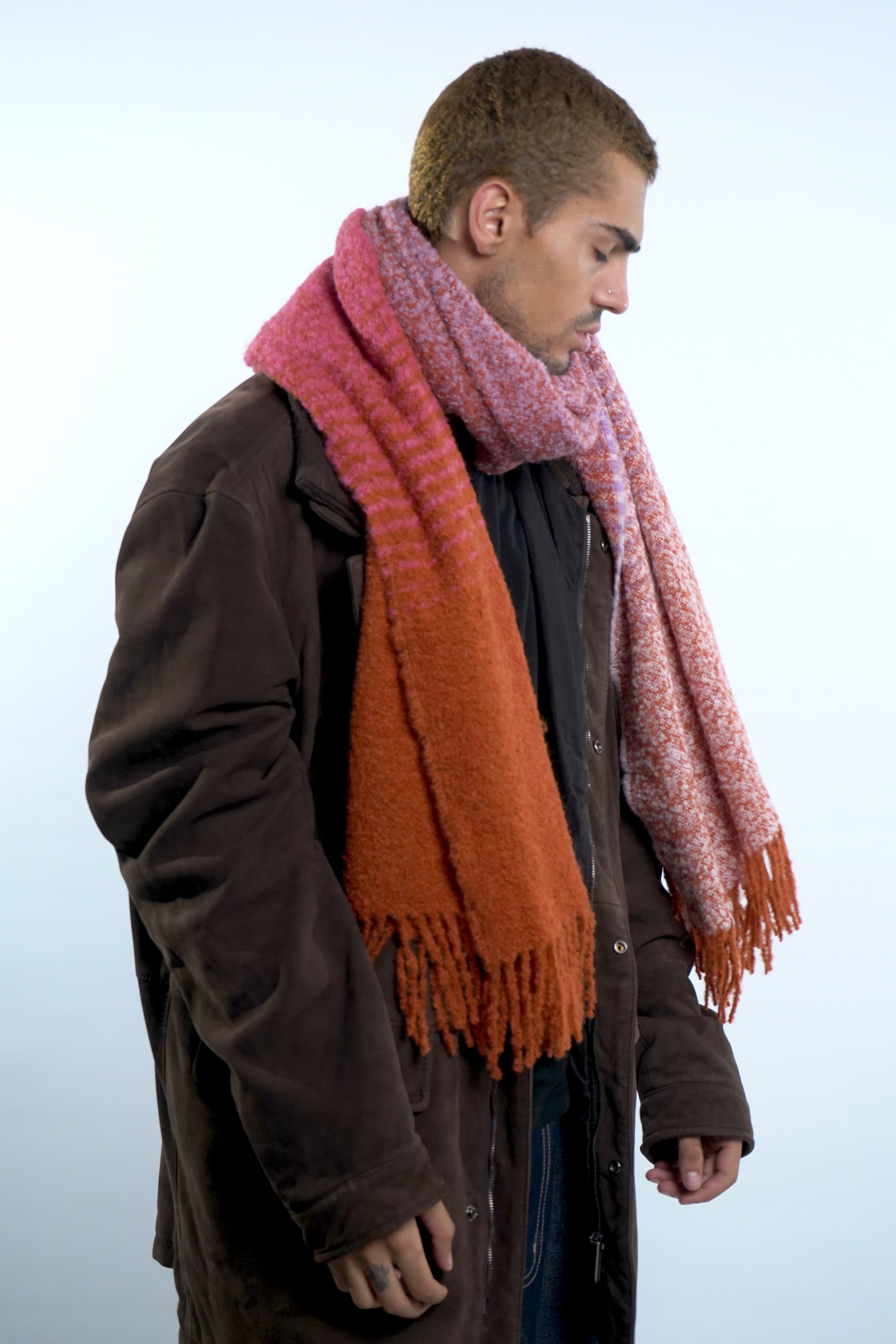 Male model wearing alpaca wool scarf around neck in pink orange lilac colors