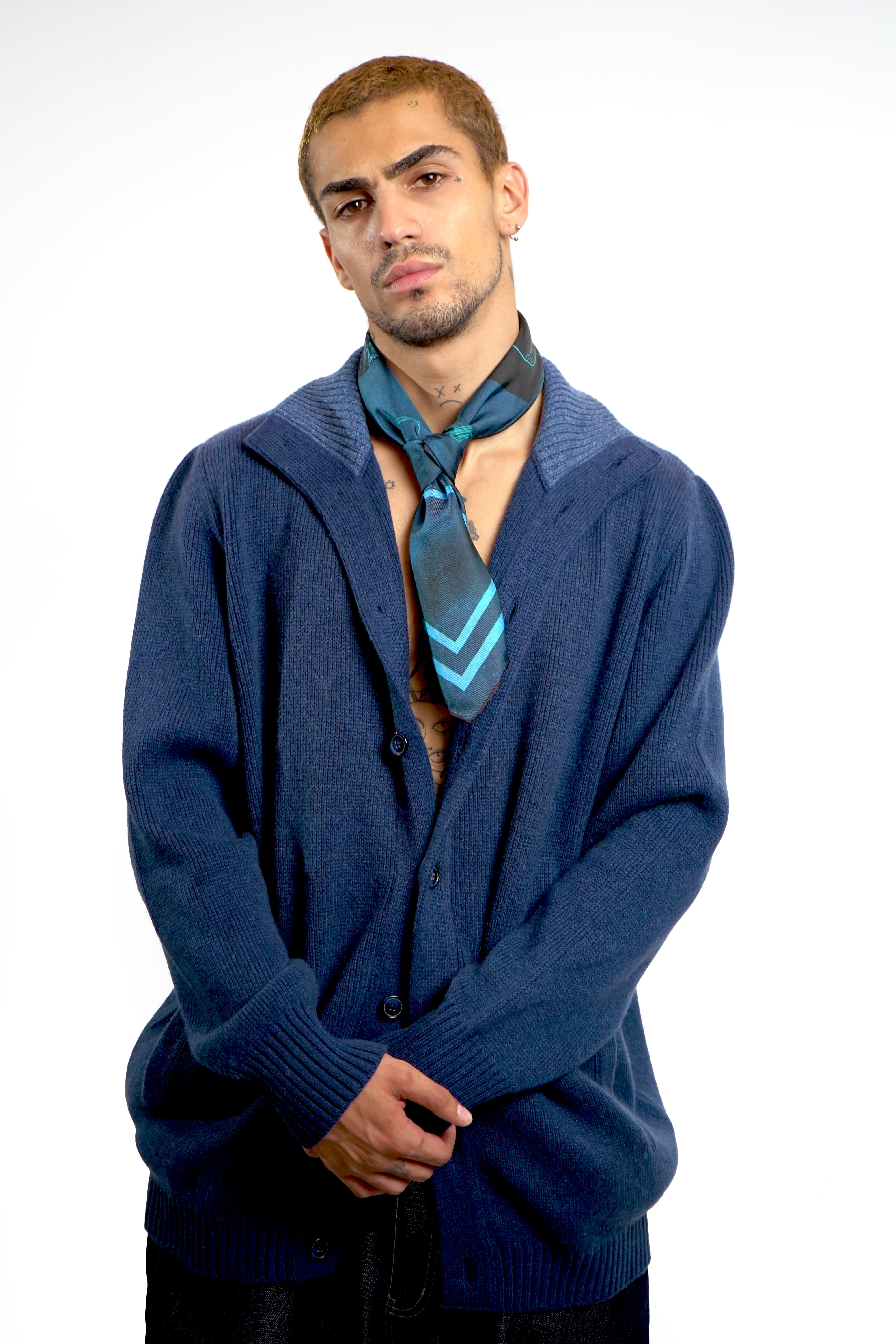 Male model wearing silk twill square scarf as tie around neck