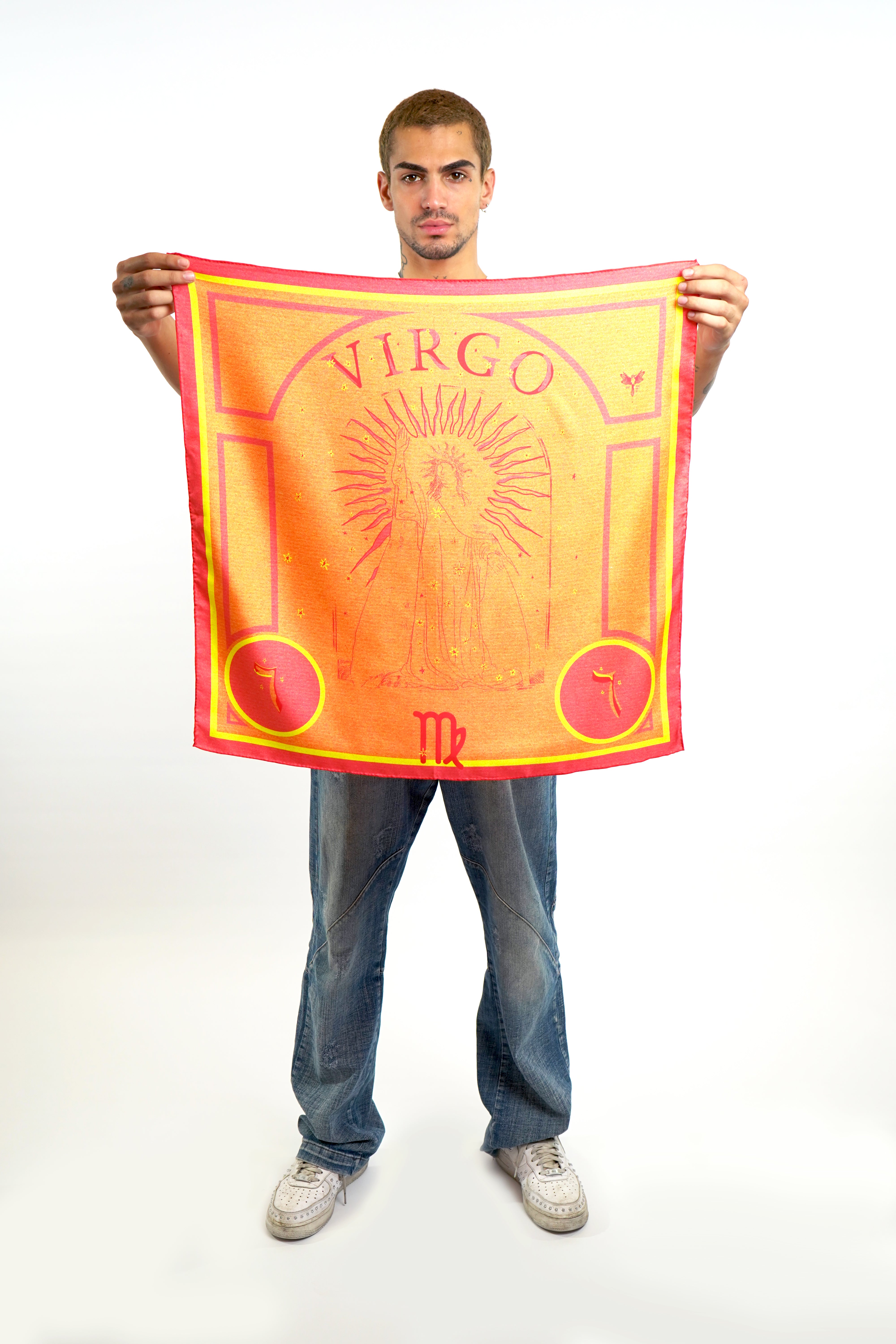 Male model holding silk twill square scarf with pink virgo design