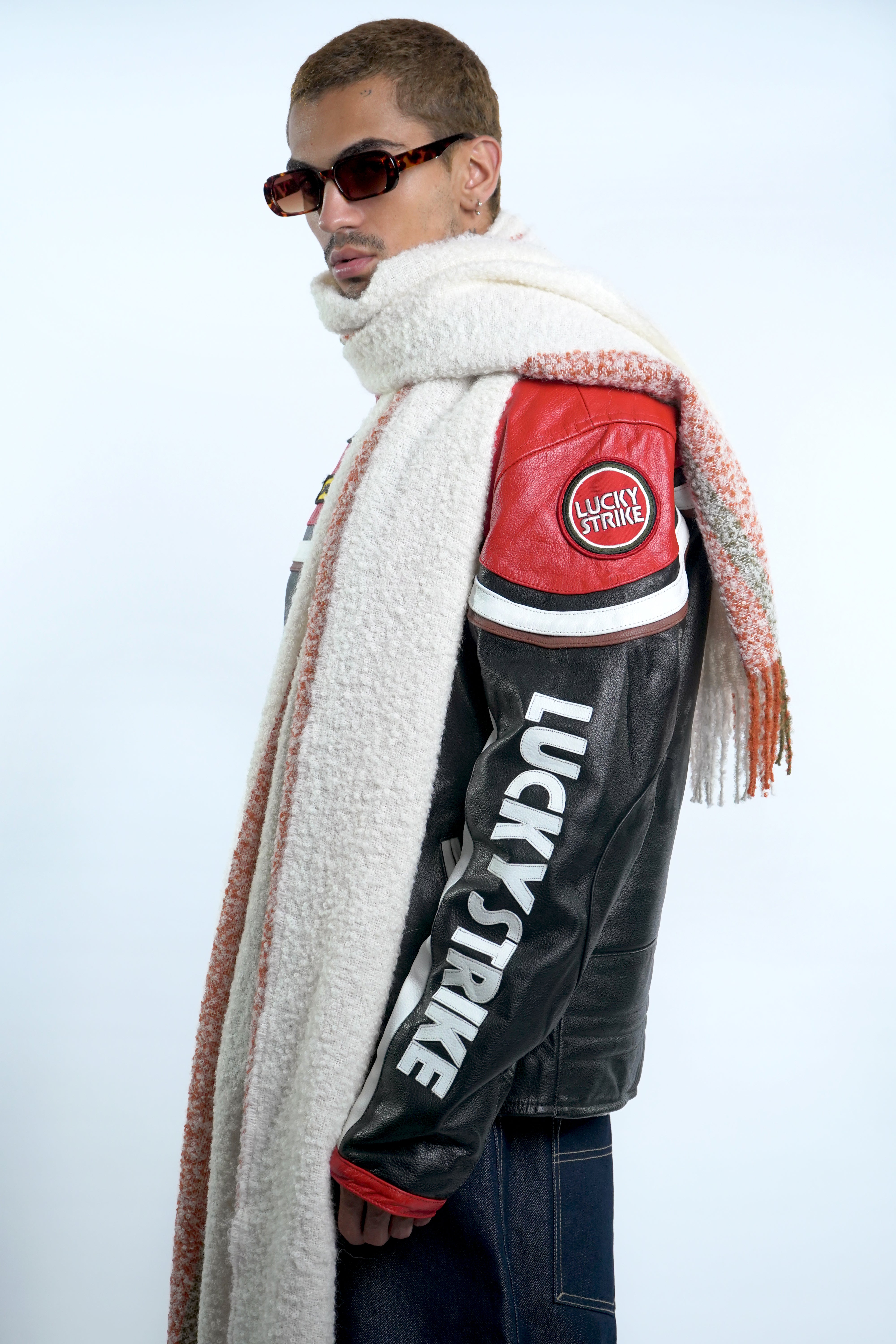 Male model wearing white alpaca wool scarf around neck for winter