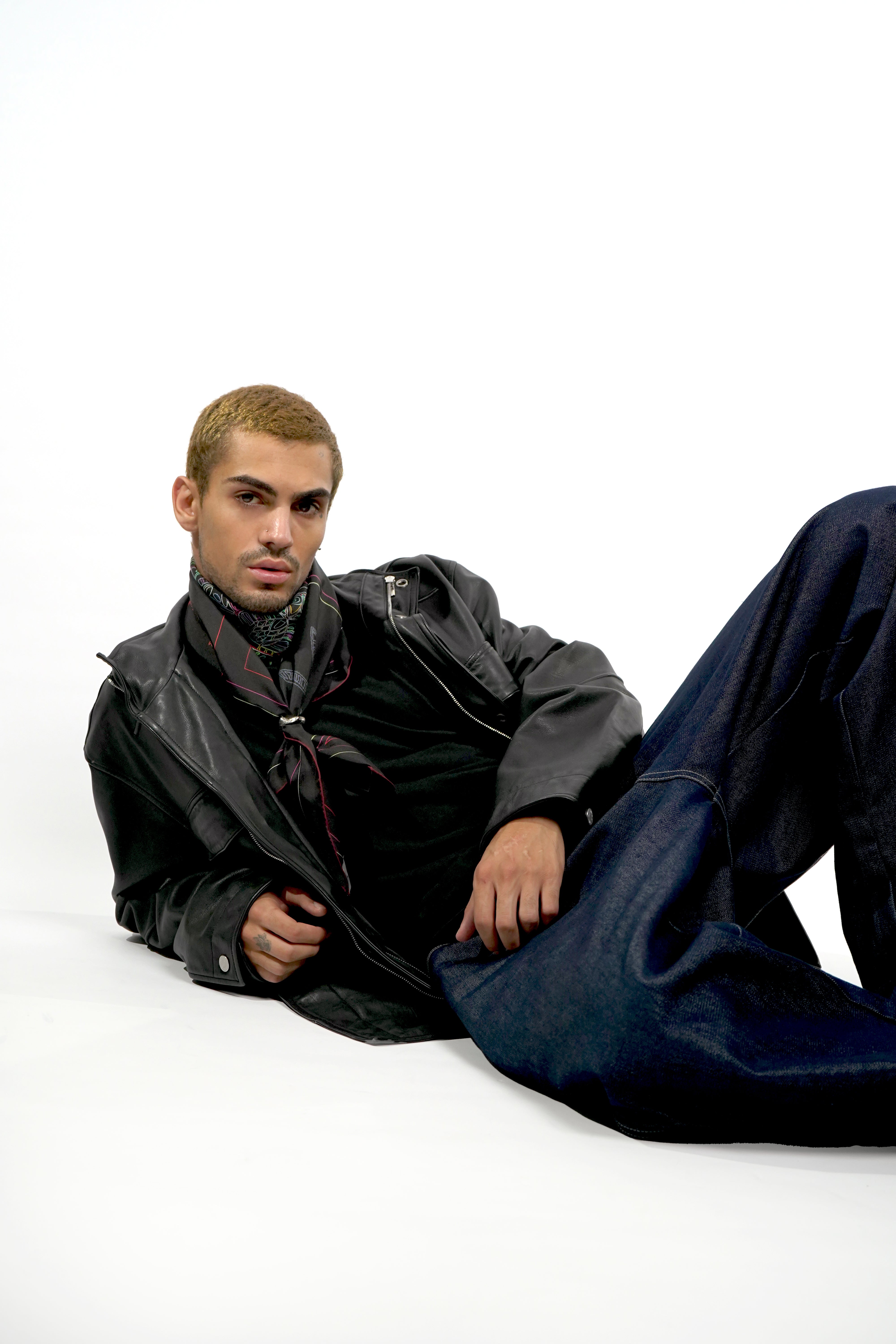 Male model wearing silk twill square scarf with scorpio print around neck